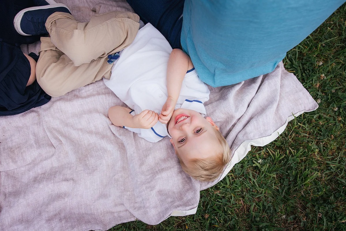 Young Child Laying on Blanket in Field at Blackwood Farm Park