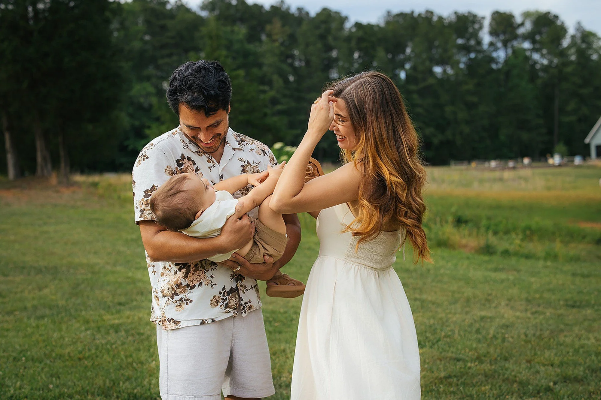 Parents Playing With Toddler Son Outside in Grass