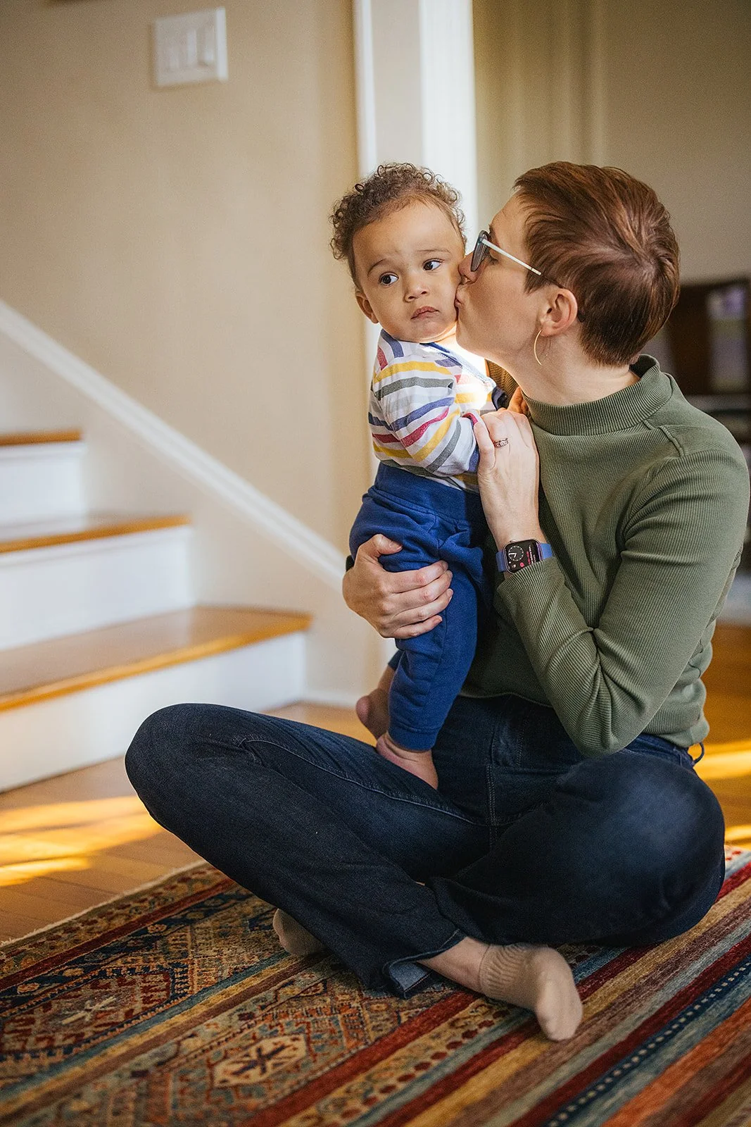 Mom Kissing Baby's Cheek During In-Home Family Photo Session
