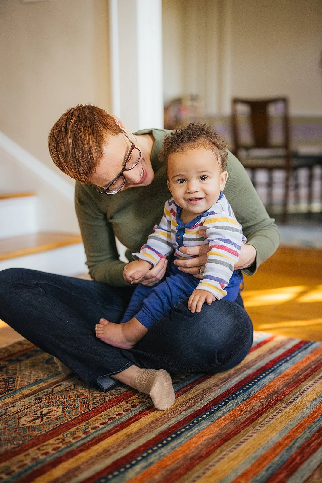 Mom Talking To Young Baby on Floor During Family Photo Session