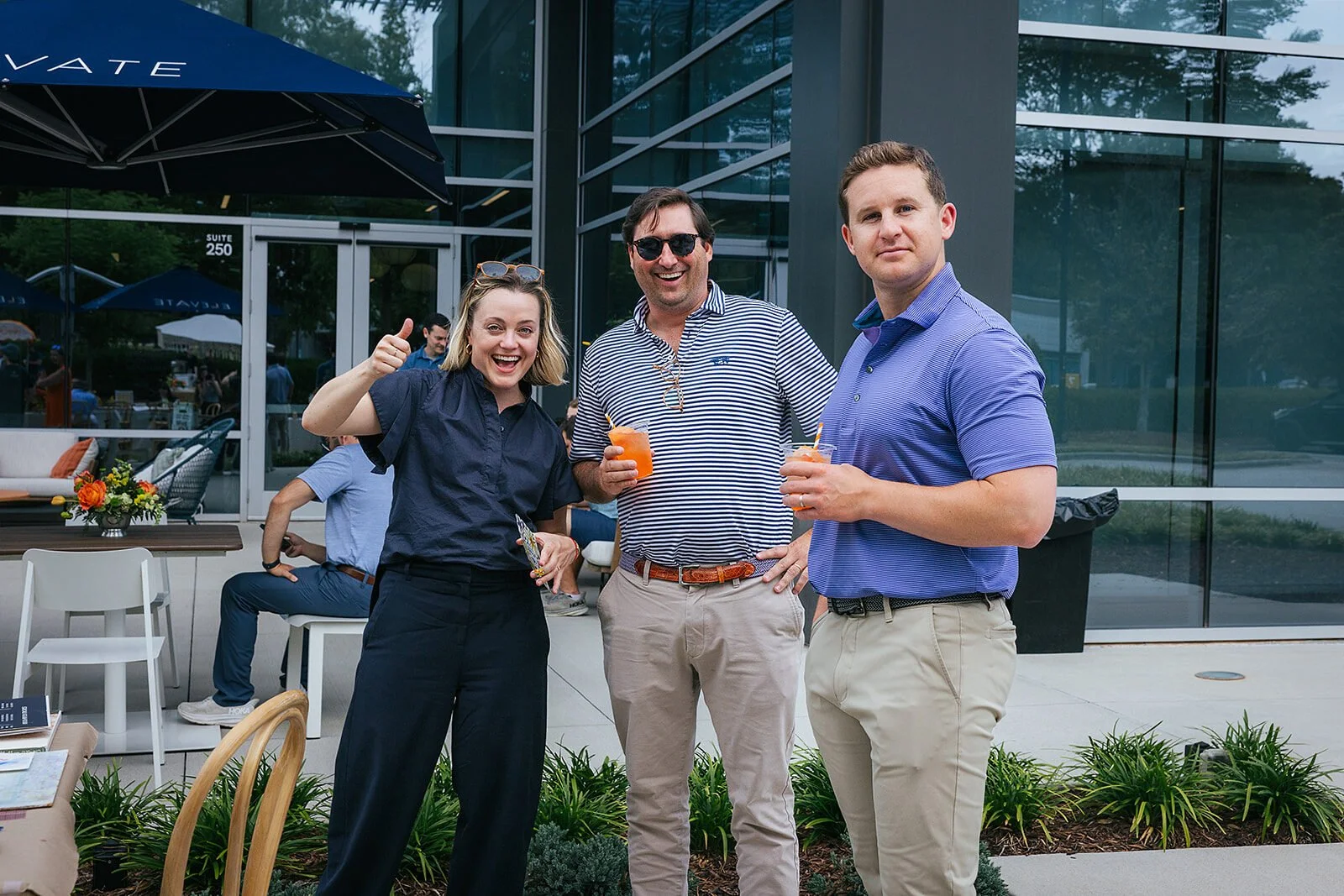 People Smiling at Raleigh Event Holding Drinks