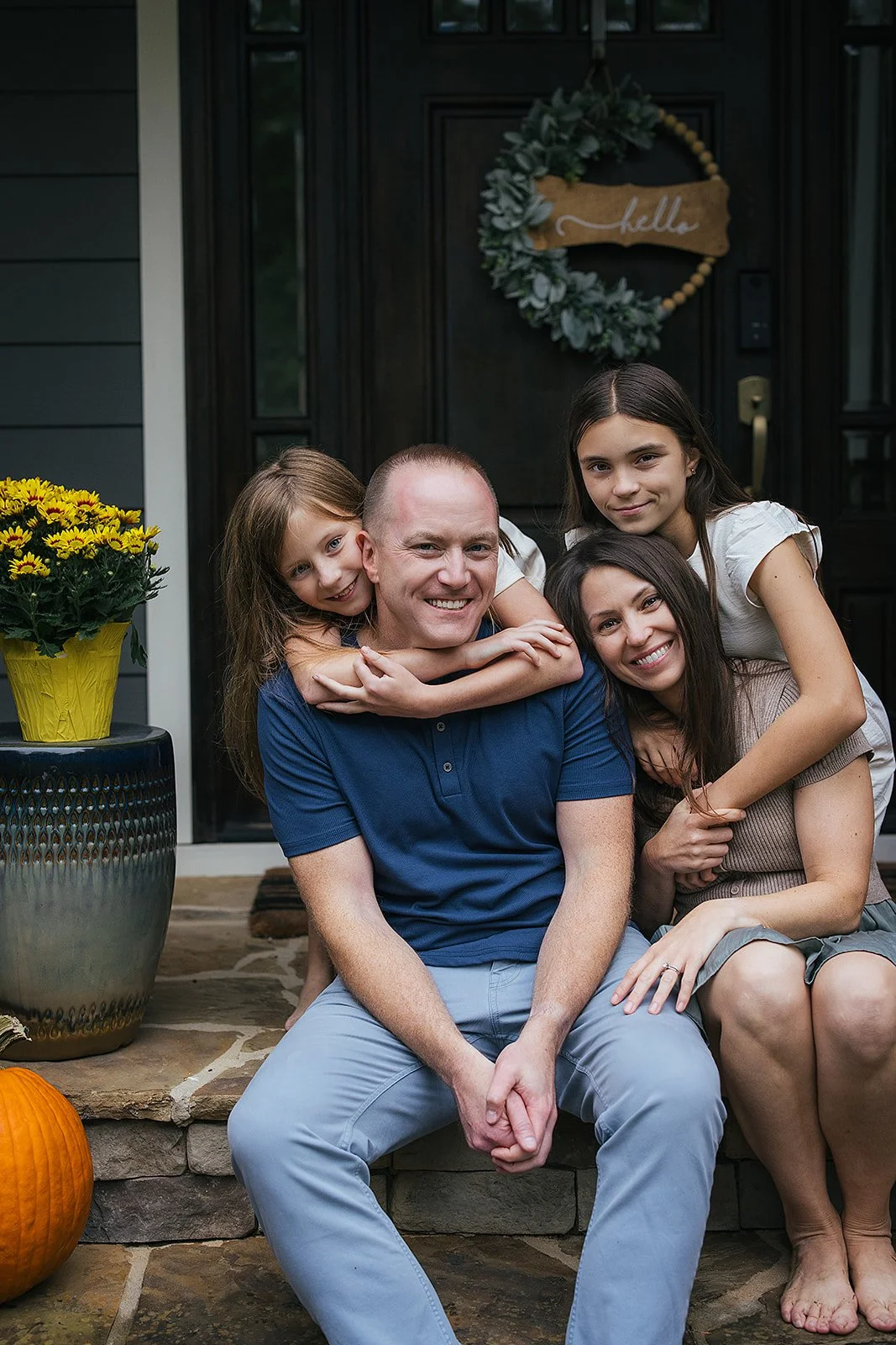 Family of four together on front porch Chapel Hill NC