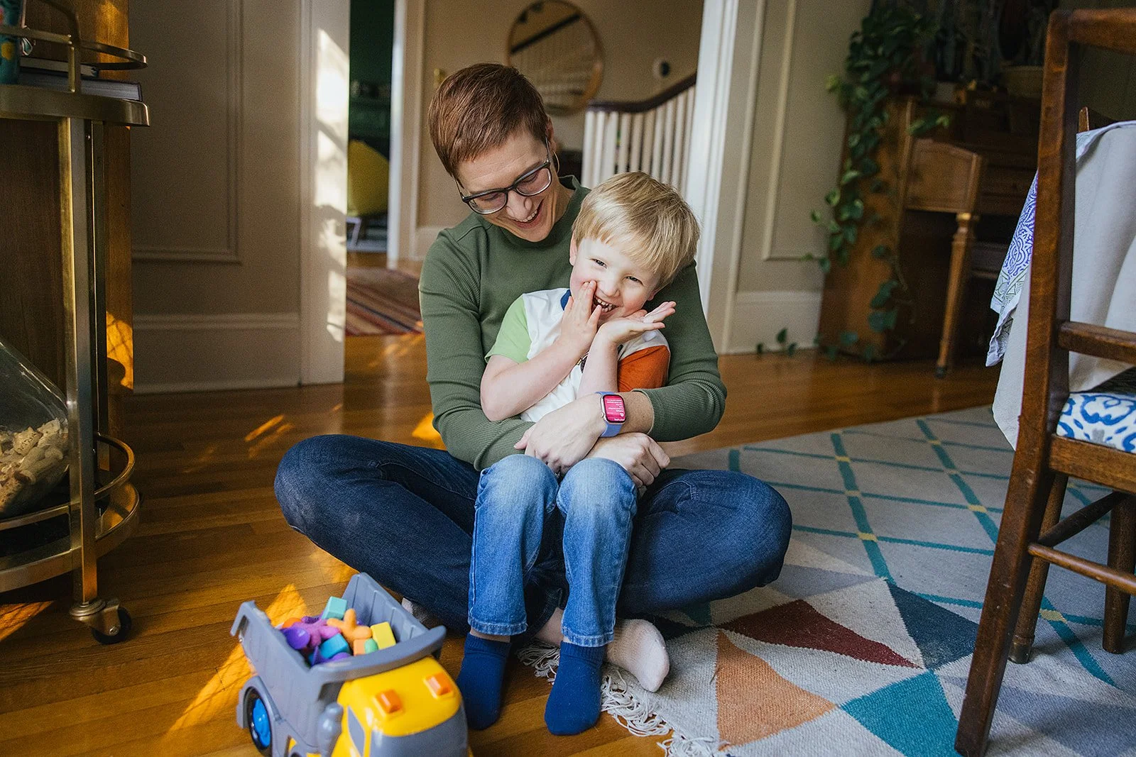 Mom and Son Laughing Together on Floor in House