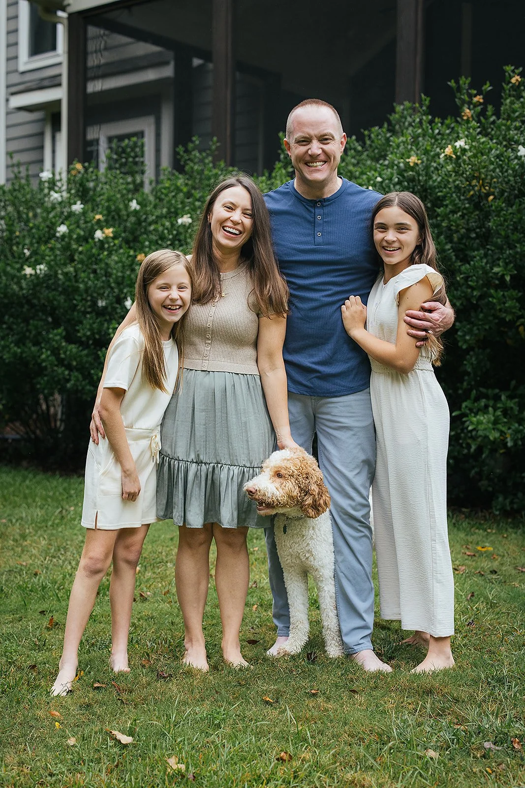 Family photographer with dog in front yard Chapel Hill NC