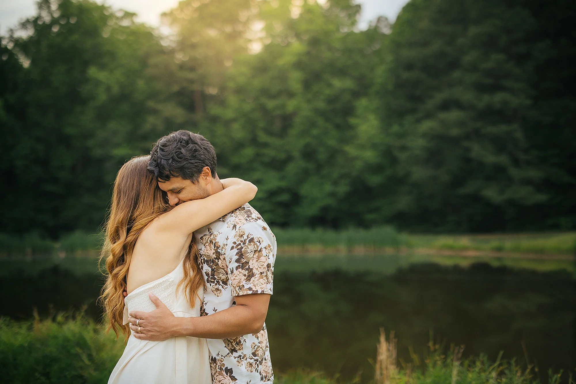 Couple Hugging In Front of Pond at Blackwood Farm Park in Durham NC
