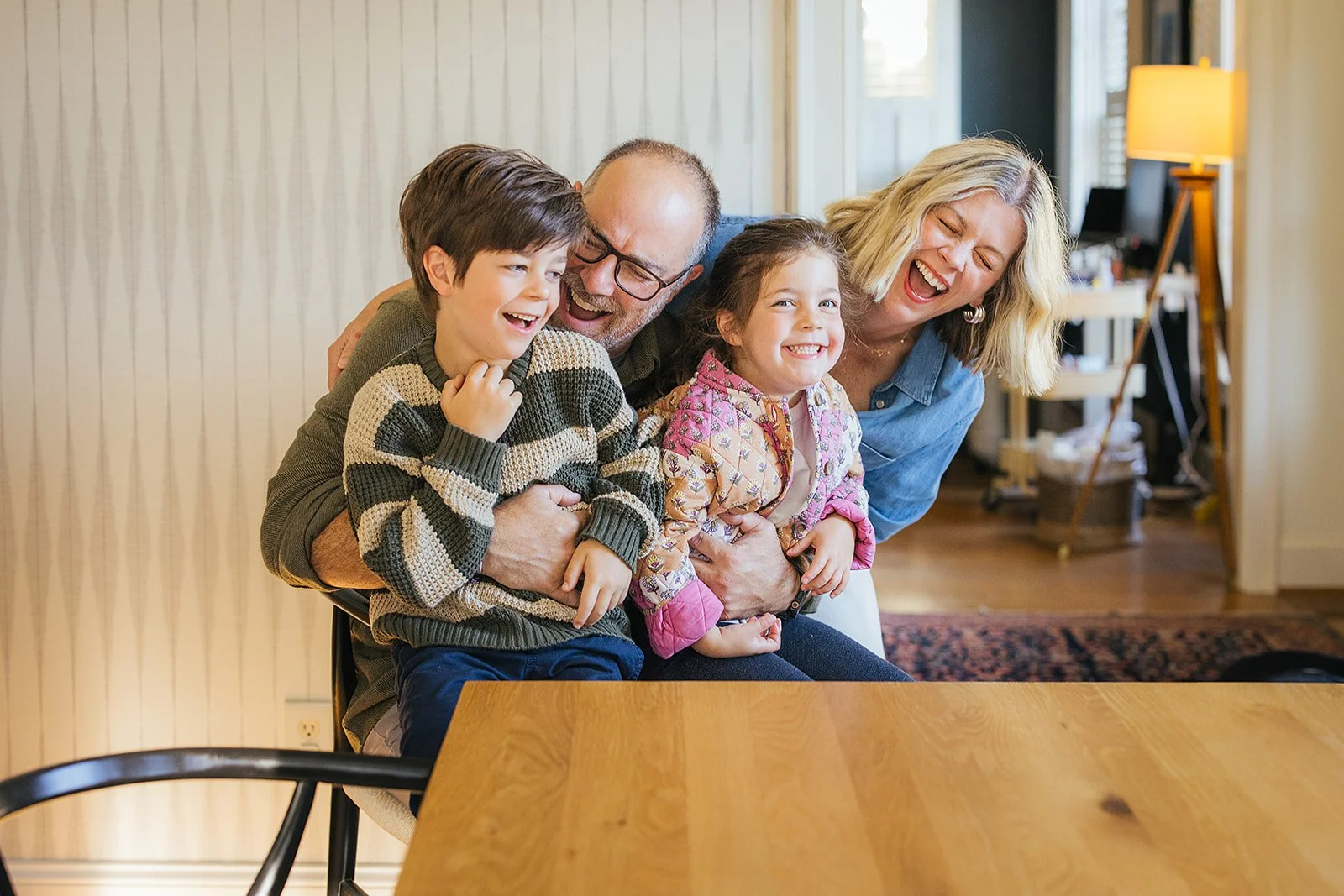 Family of Four Smiling and Laughing Together During Family Photo Session