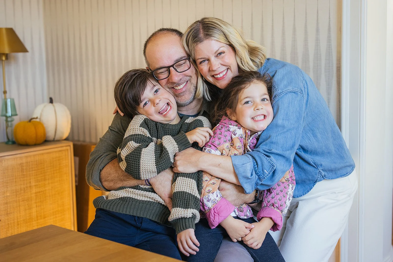 Family of Four Smiling Together During Family Photo Session