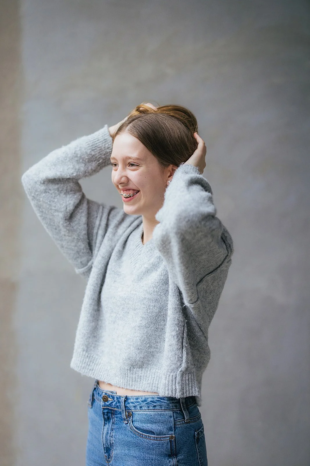 Young Girl in Grey Sweater Posing During Personal Branding Session