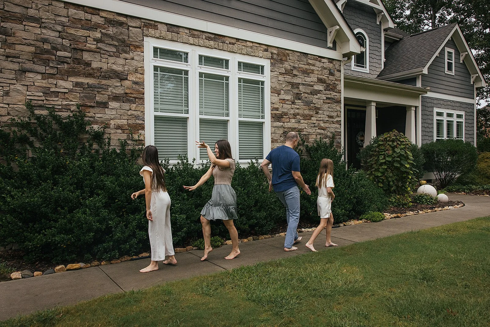Family playing and dancing in front yard Chapel Hill NC