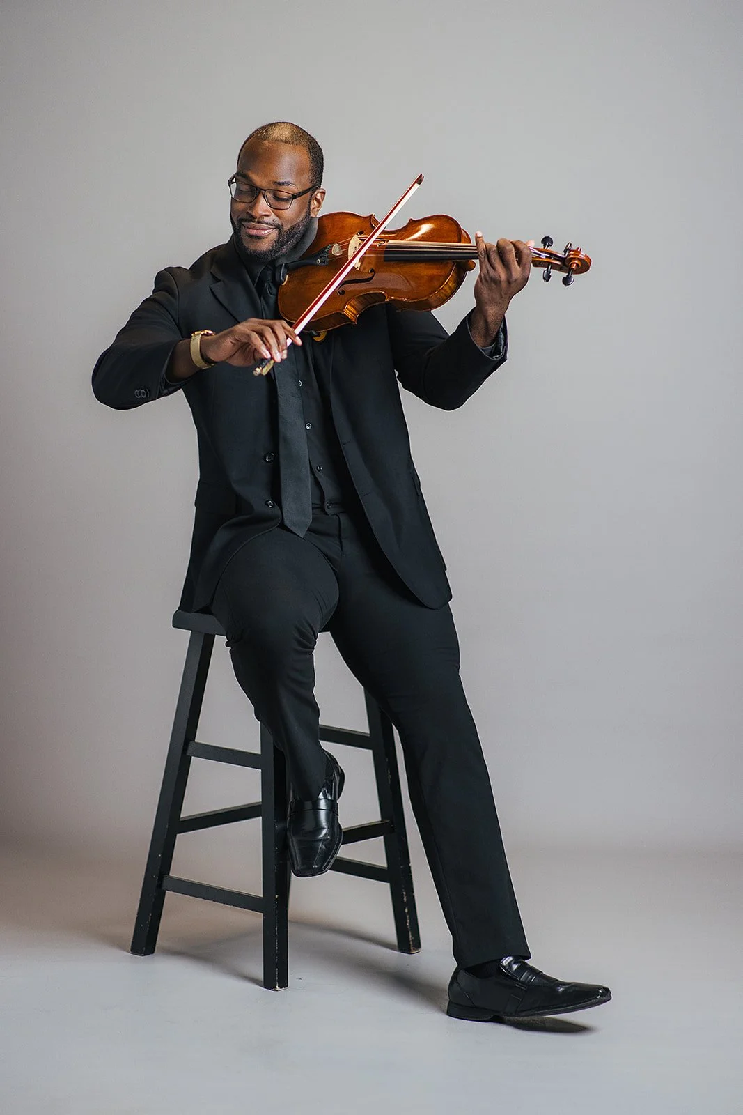 Member of Chamber Orchestra of Triangle Playing Violin