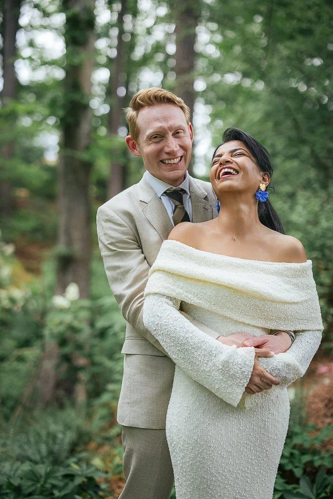 Husband and wife smile after vow renewal at Duke Gardens in Durham, NC