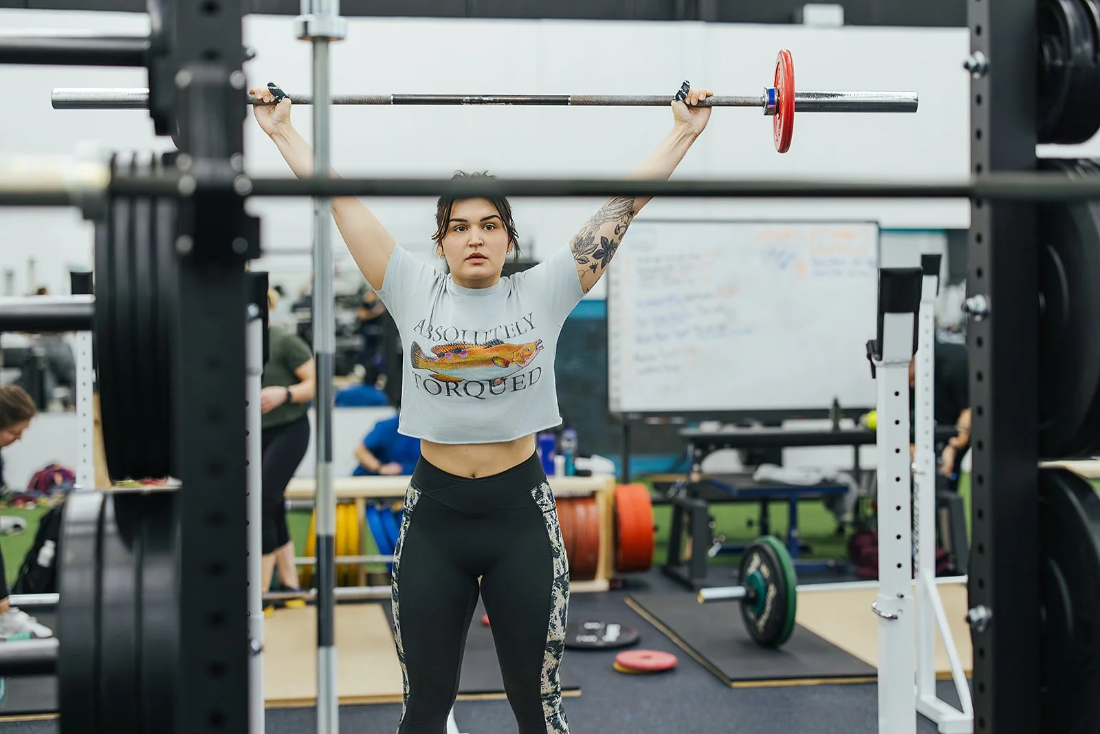 Person lifting weights during a sports club photoshoot