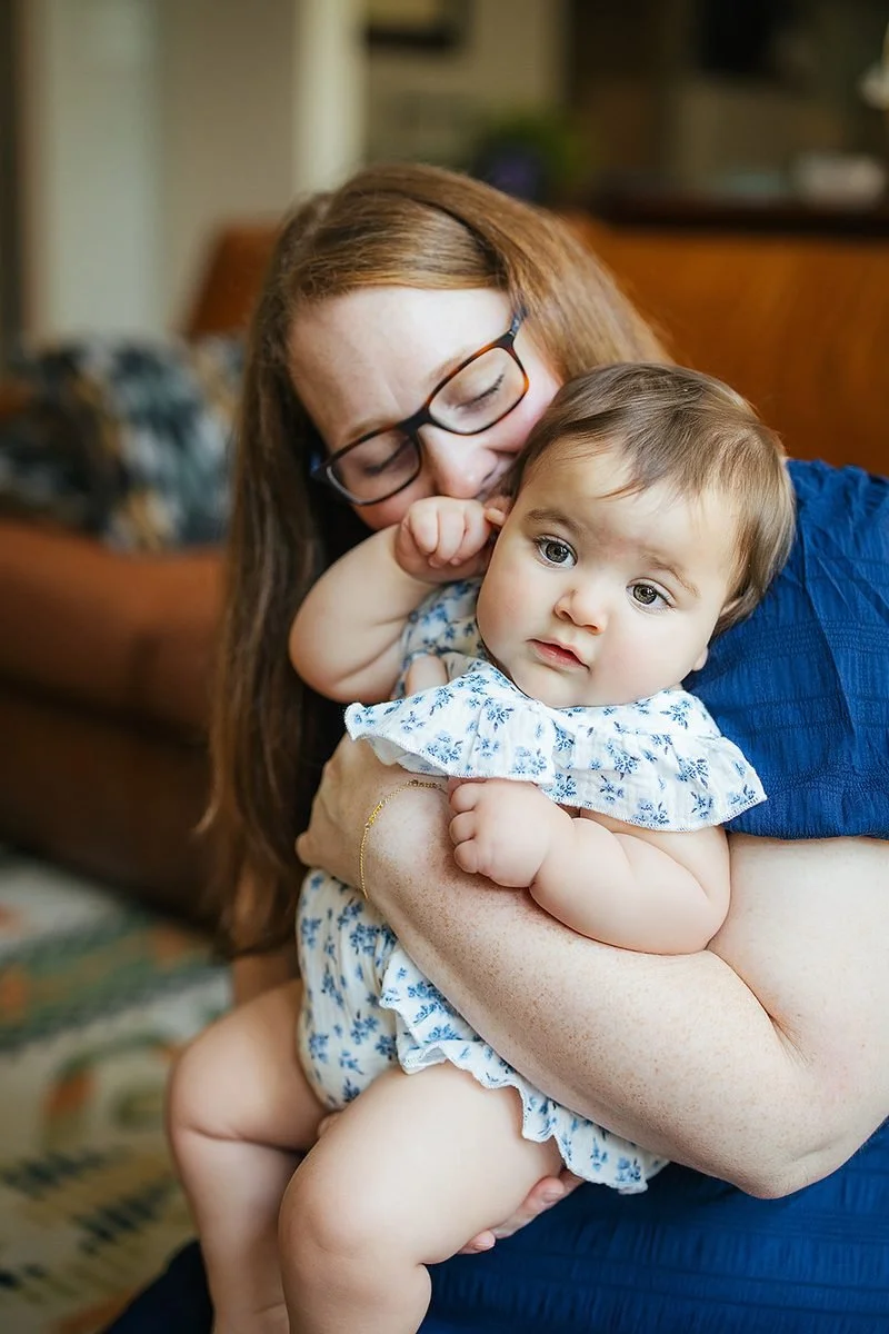 Mom snuggling baby during in-home family photography session in Durham NC