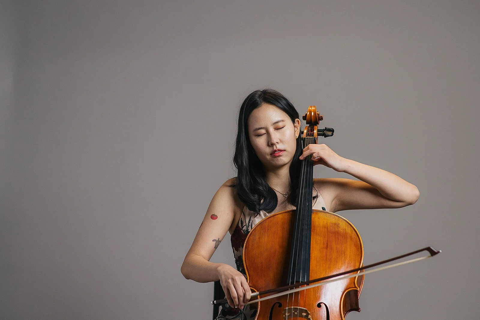 Woman Playing Cello During Branding Photography Session
