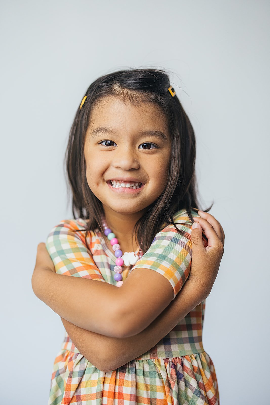 Young Girl Colorful Dress Smiling During In Studio Portrait Session