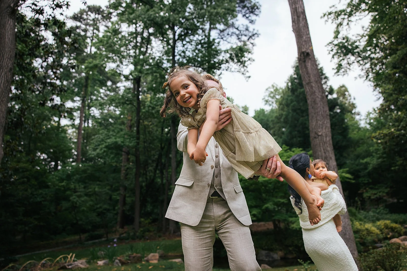 Young Girl In Dress Held by Dad in Duke Gardens