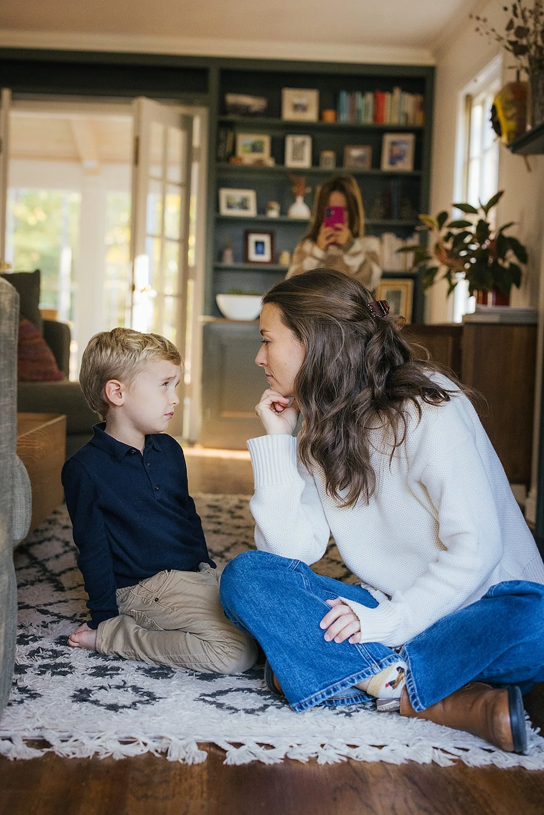 MomSittingOnCarpetWithYoungSonFamilyPhotoSession