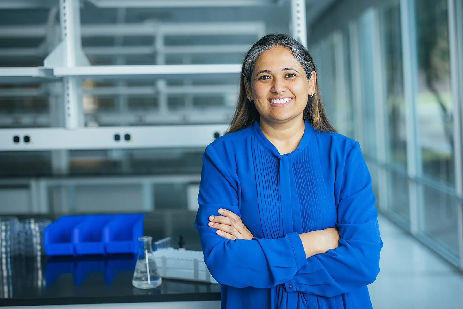 WomanInBlueShirtArmsCrossedInLab
