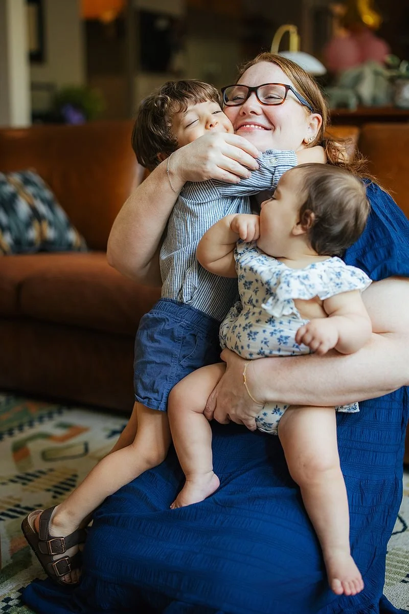 Mom hugging two young children in living room family photograhy durham