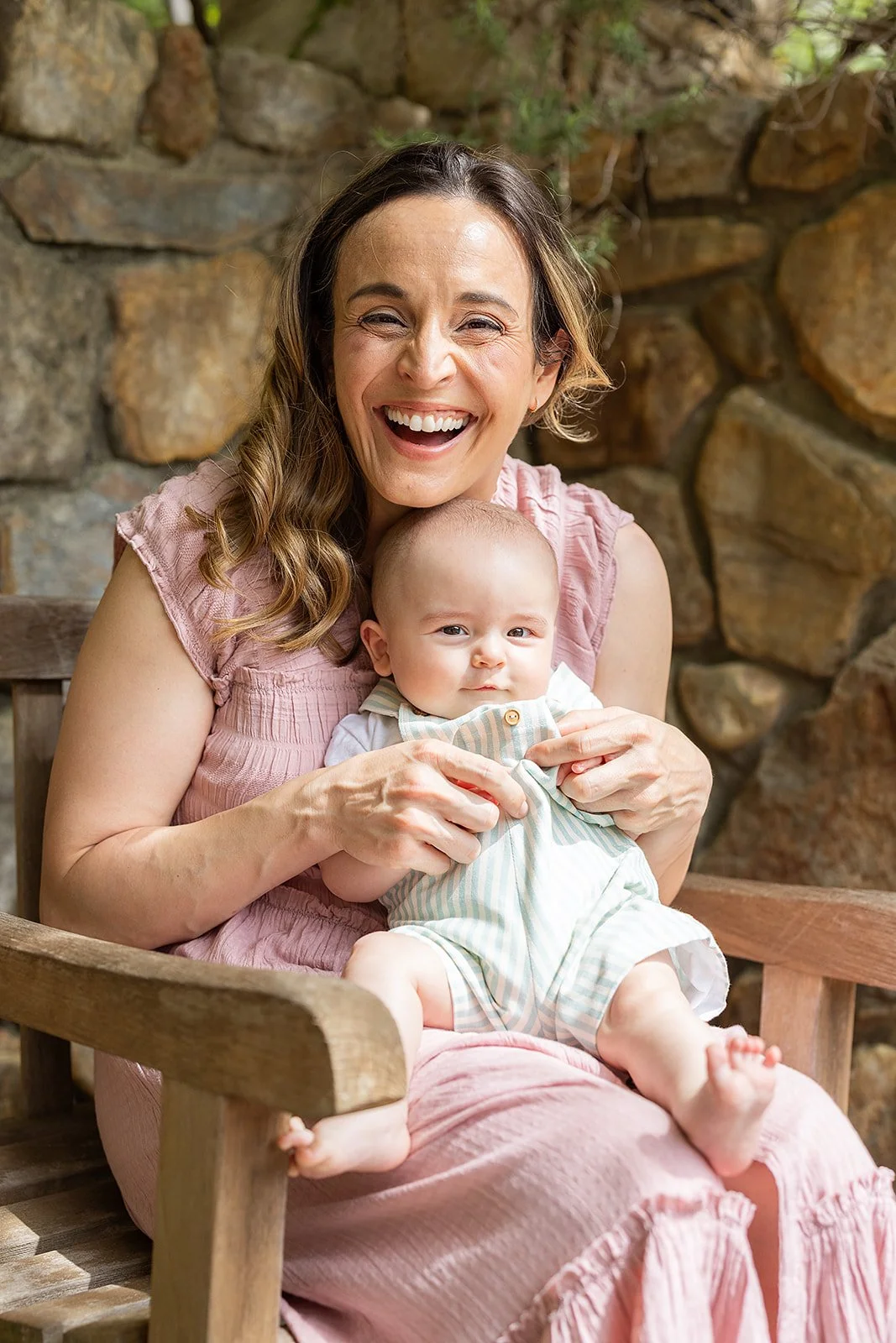 Mom in Pink Dress Holding Young Baby