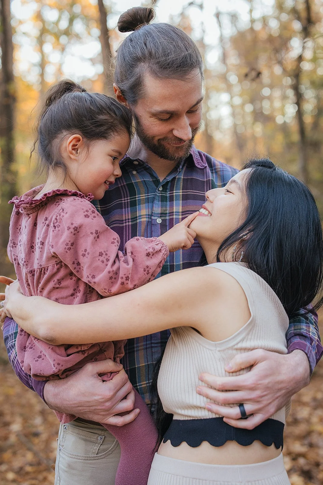 a loving family with one child poses for family photos in Durham, North Carolina