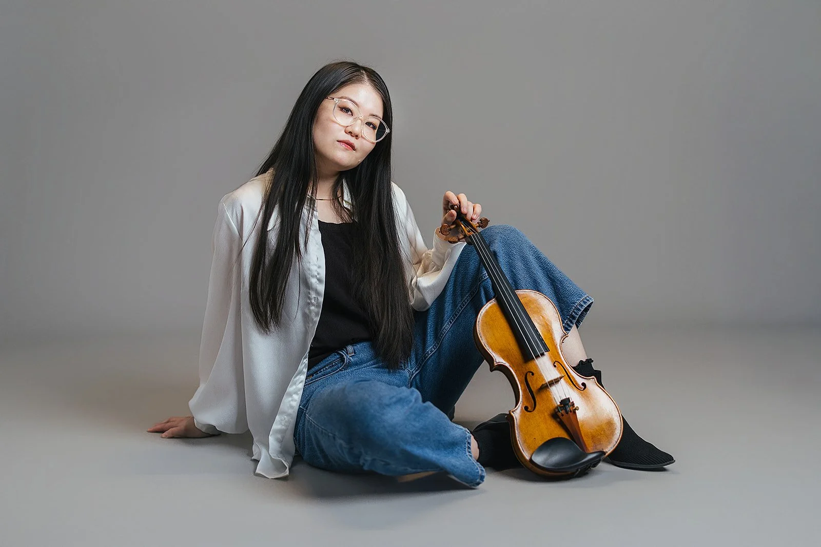 Woman Sitting with Violin During Photography Session