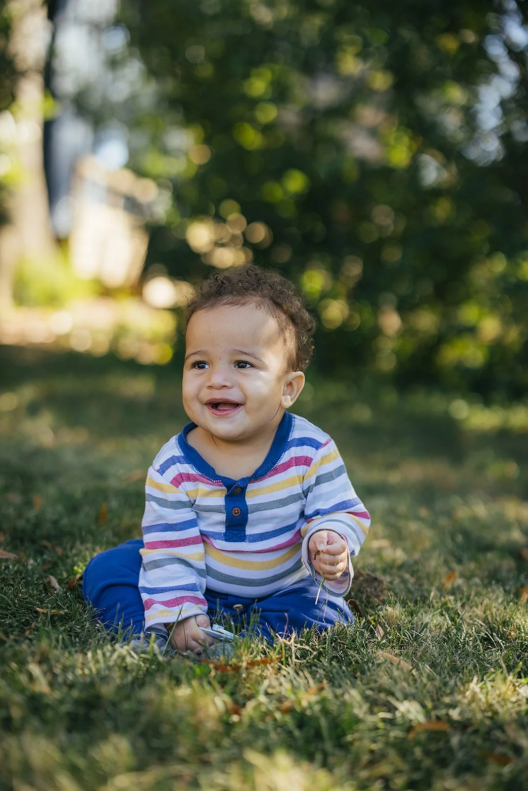 Young Baby Smiling and Sitting in Grass