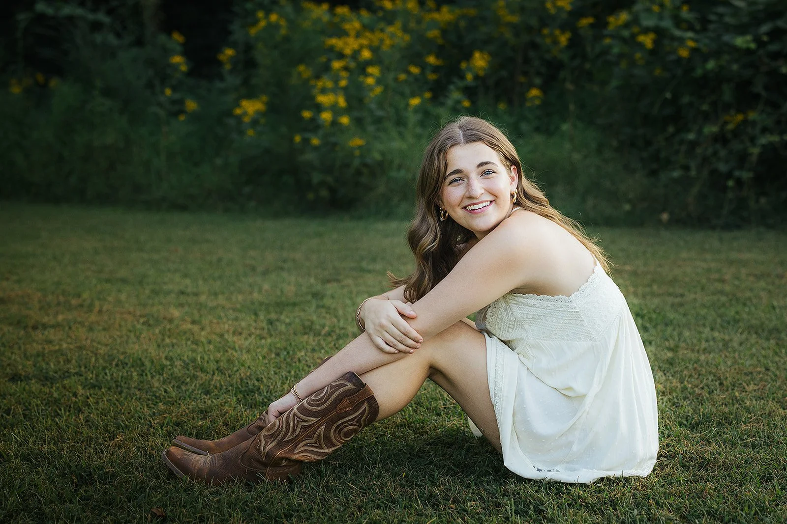 Senior Girl Smiling Sitting in Grass During Portrait Session