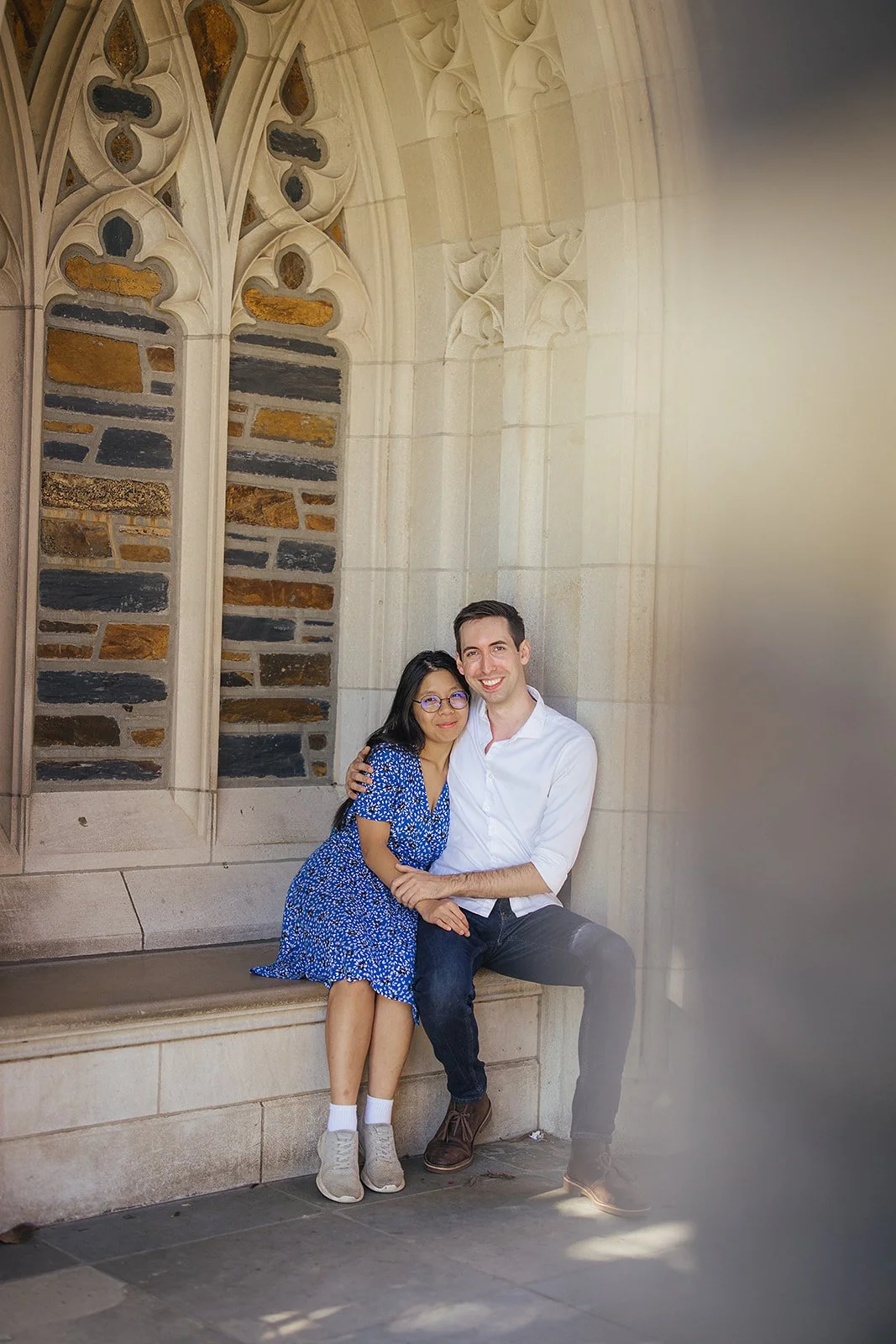 A couple snuggles together after their surprise engagement during a photoshoot at Duke Gardens in Durham, NC
