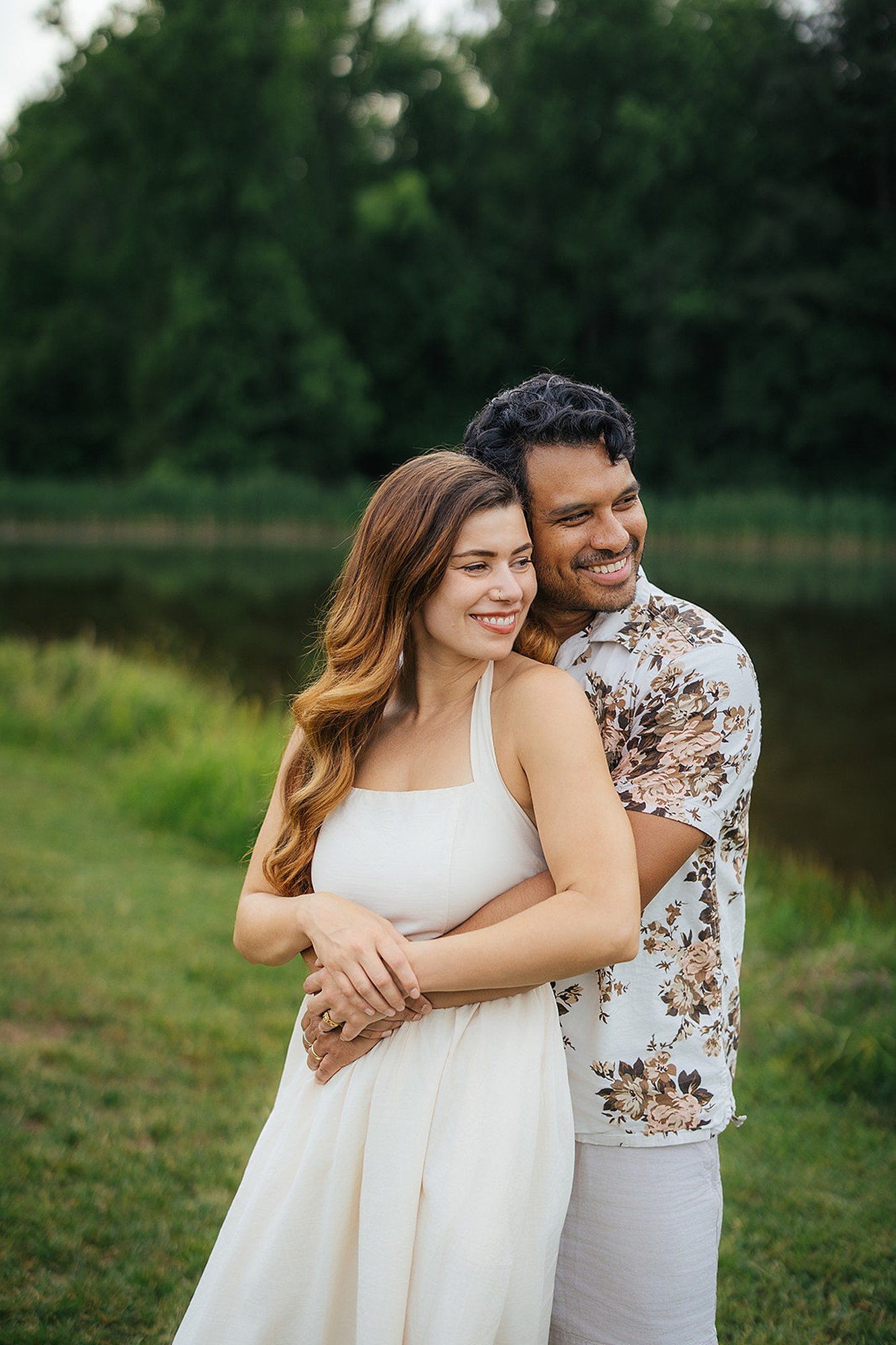 Couple Hugging and Smiling in Front of Waterfront