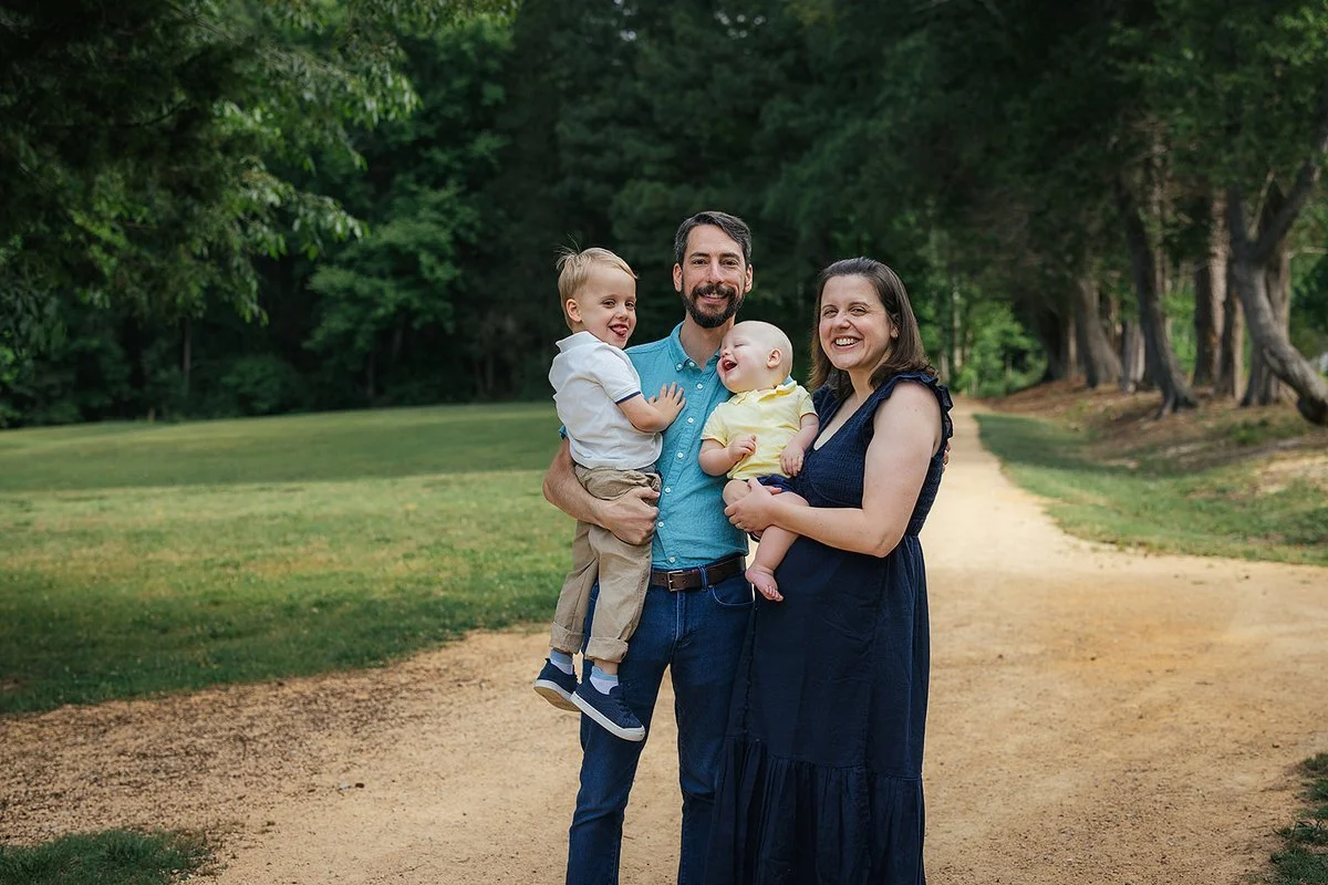 Family laughing together in golden light at Blackwood Farm Park, Chapel Hill NC