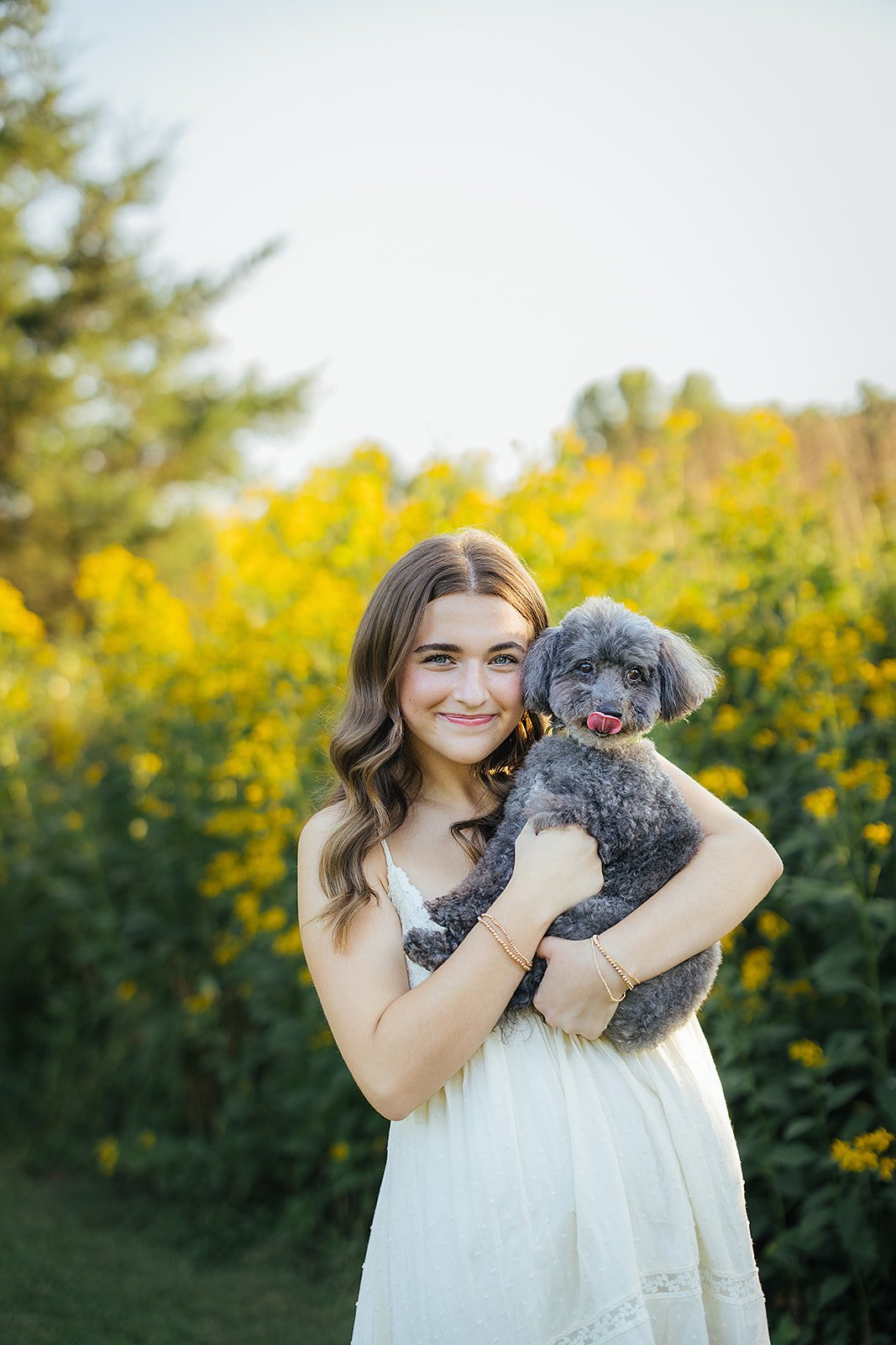 Senior Girl Smiling with Dog During Senior Photography Session