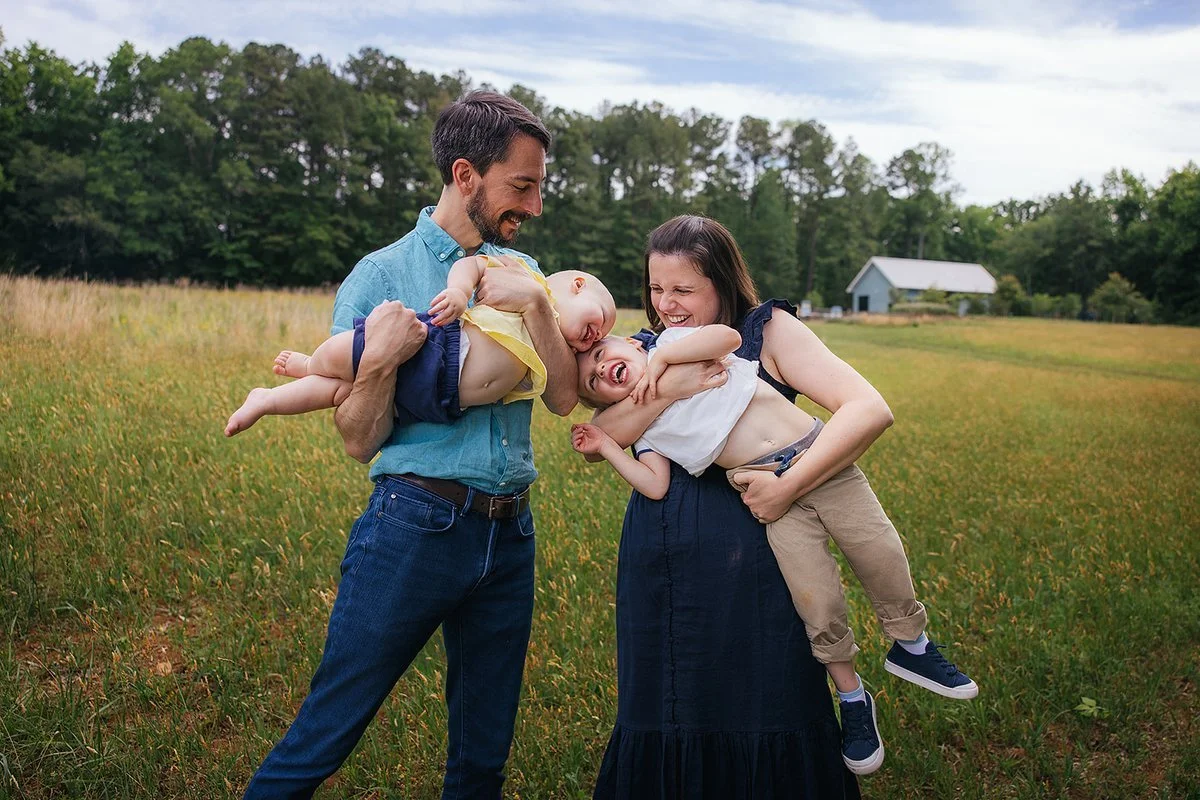 Family portrait in a sweeping field at Blackwood Farm Park, Durham family photographer