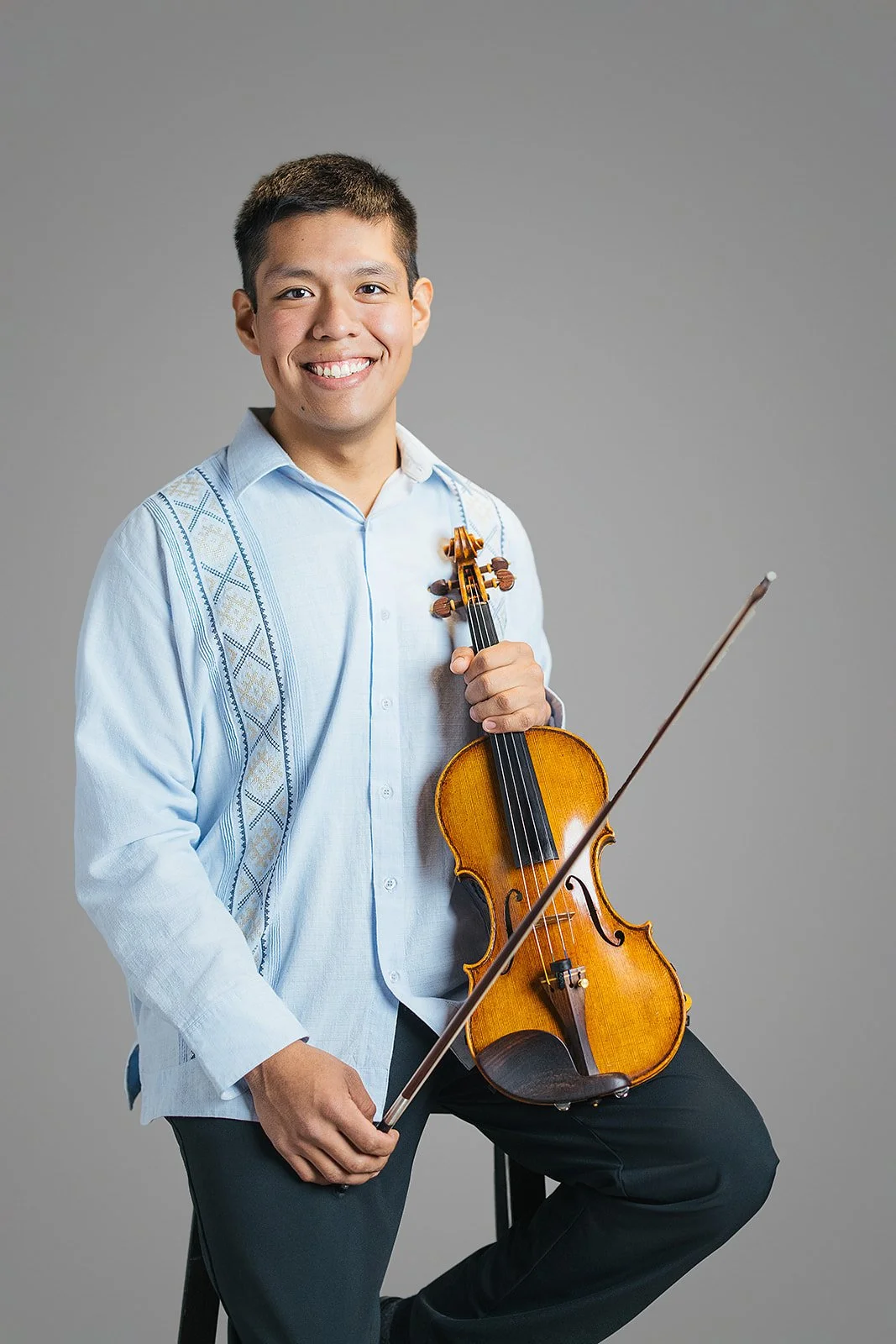 Member of Chamber Orchestra of the Triangle Posing with Violin