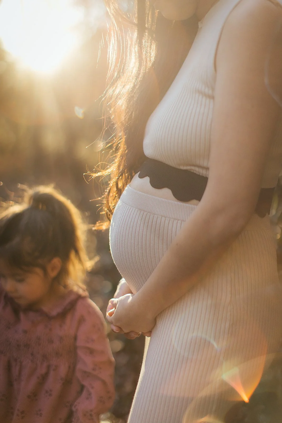 Sunlight between a mother and daughter during a family photoshoot in Durham, NC