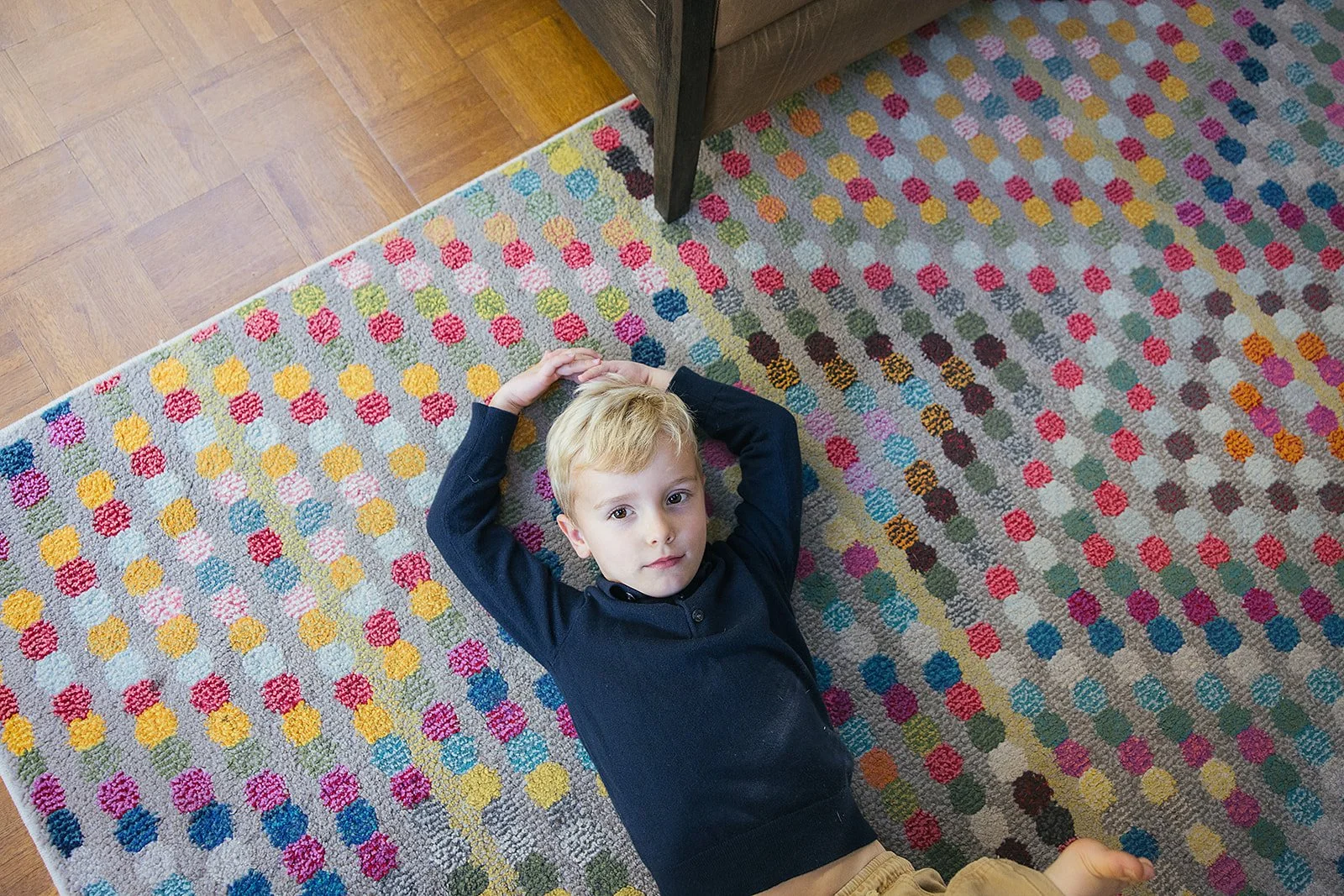 YoungBoyLayingOnColorfulCarpet
