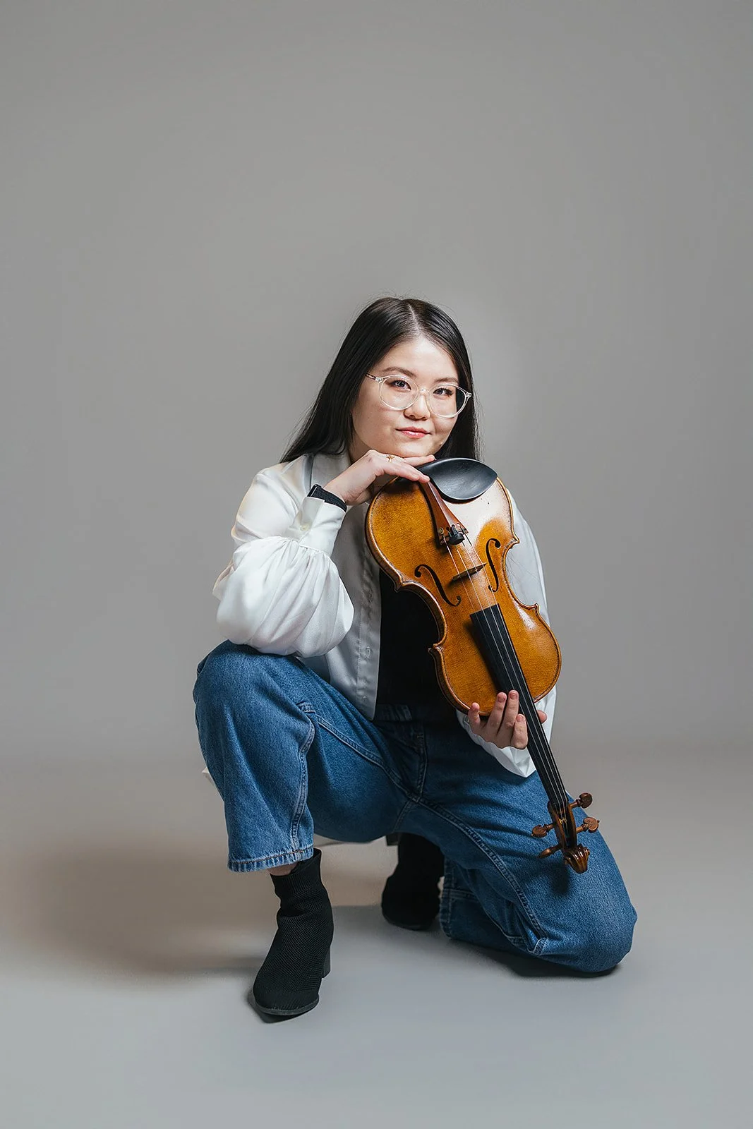 Woman Kneeling and Smiling with Violin