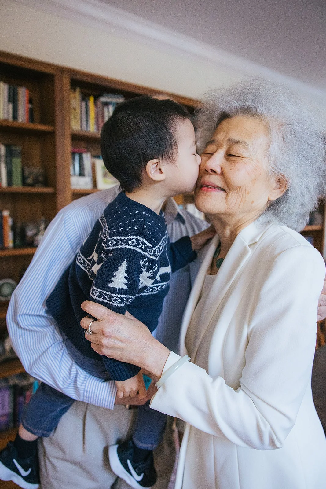 Grandson kissing grandmother on cheek Family portrait session Durham NC