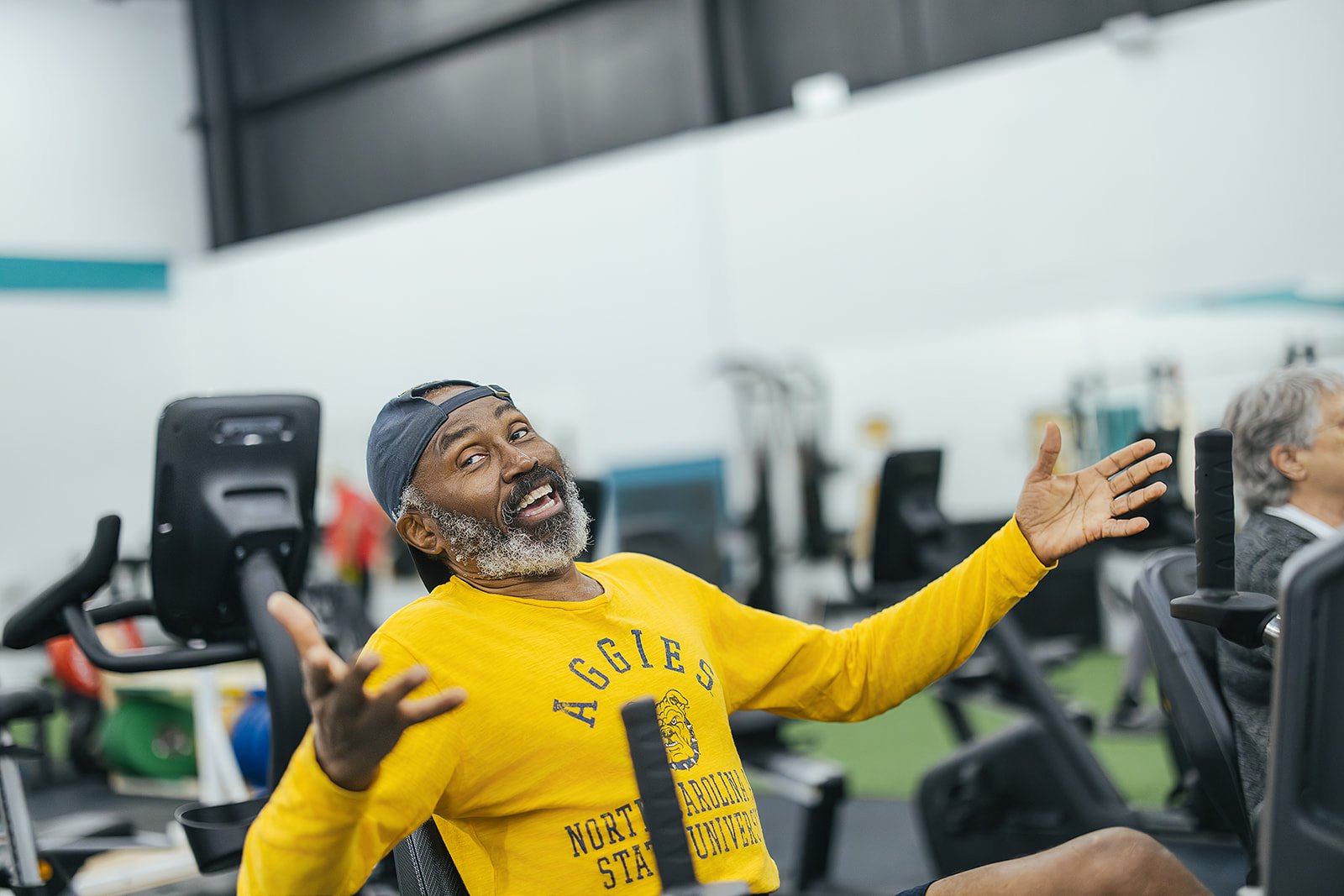 joyful man poses at Durham, NC wellness center for local business photography