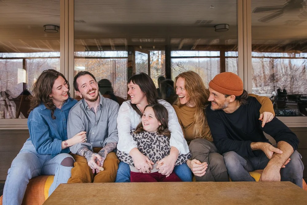 Family and Friends on Couch Smiling and Laughing