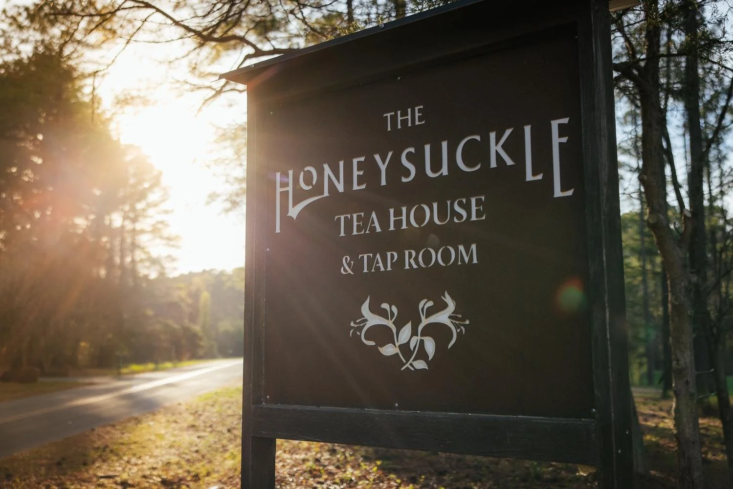 The Honeysuckle Tea House and Tap Room venue sign bathed in beautiful golden evening light in Chapel Hill NC