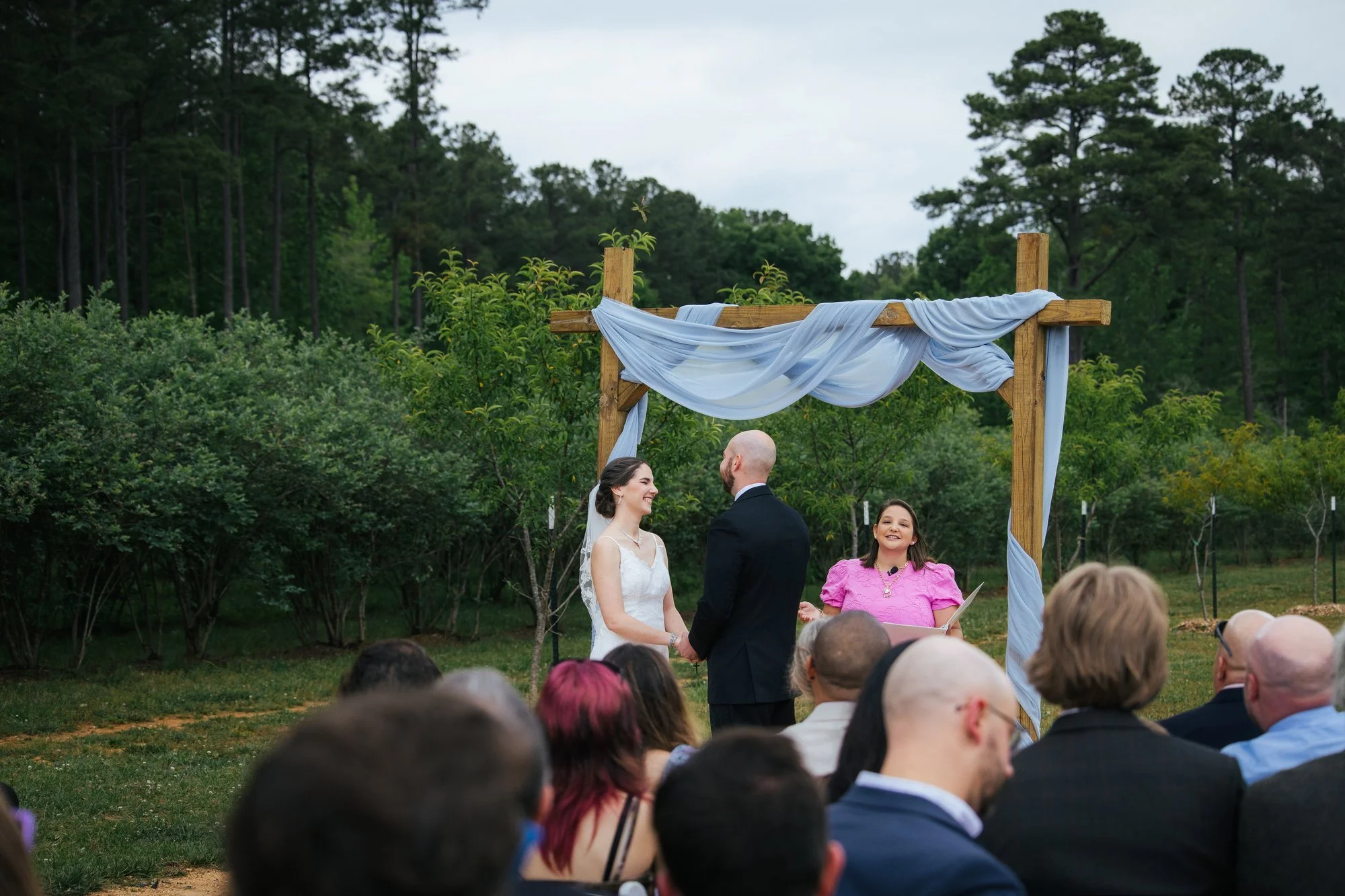 Bea and Tim exchanging vows at The Honeysuckle Tea House Chapel Hill — wedding photographer
