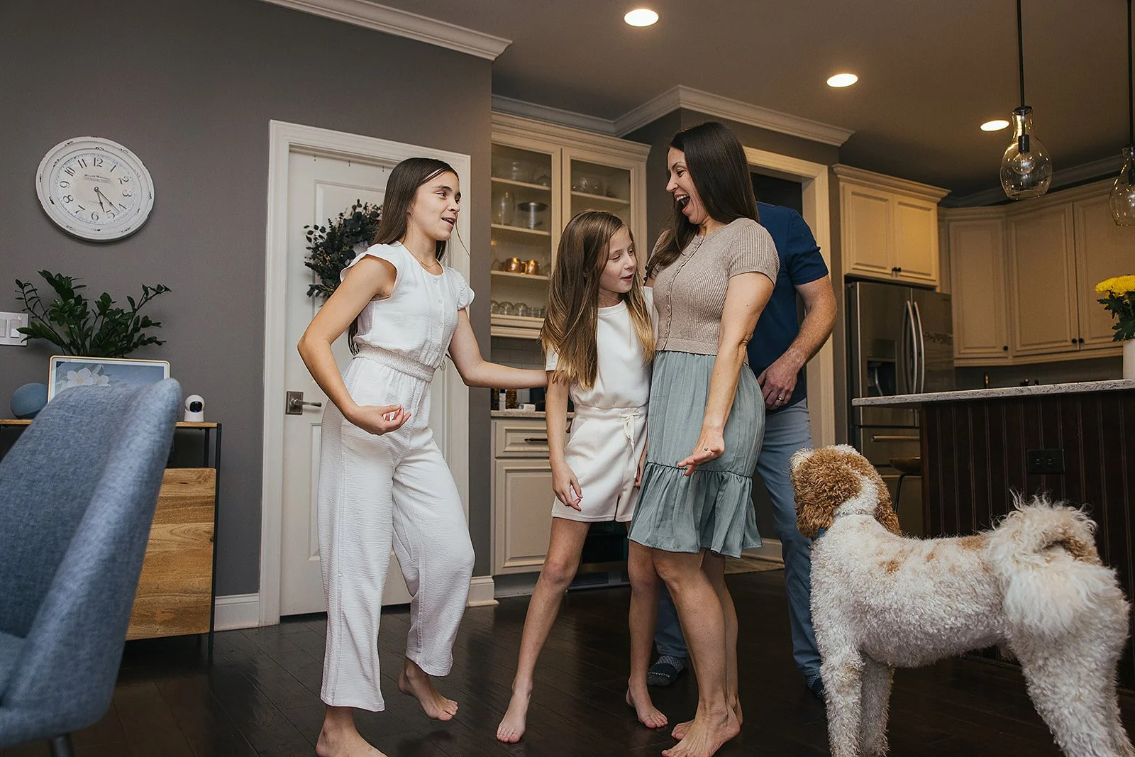 Family dancing in kitchen with dog in-home family photography session Chapel Hill NC
