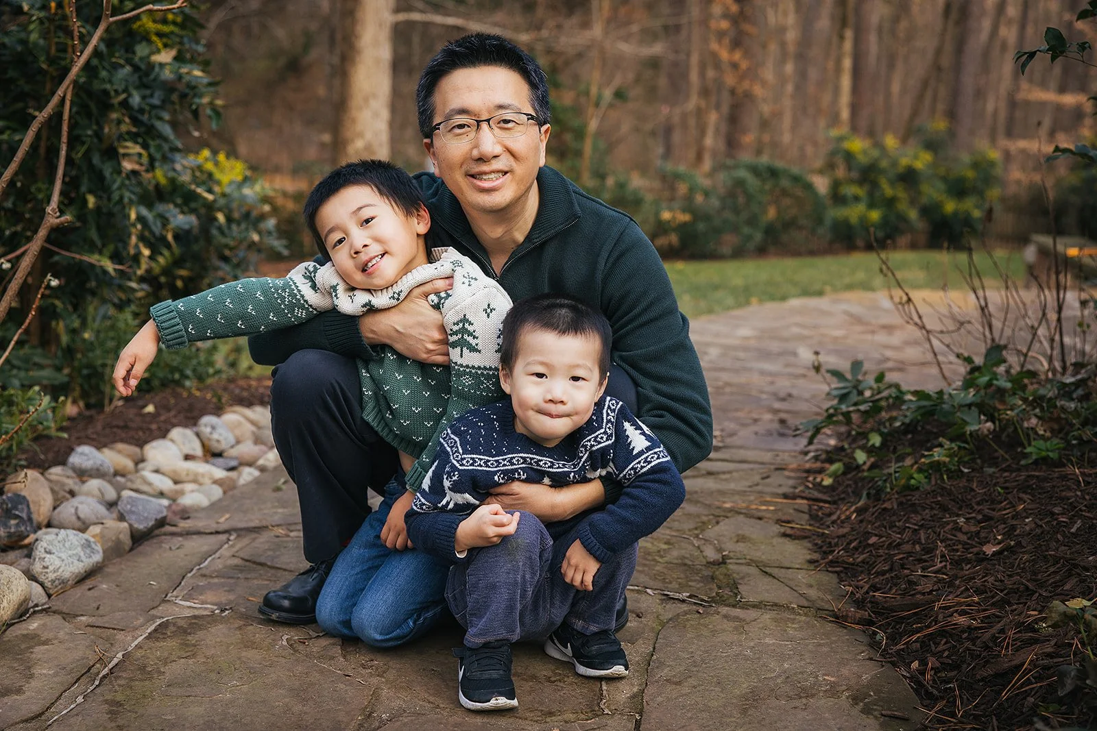 Dad outside with two young boys during family portrait session in Durham NC