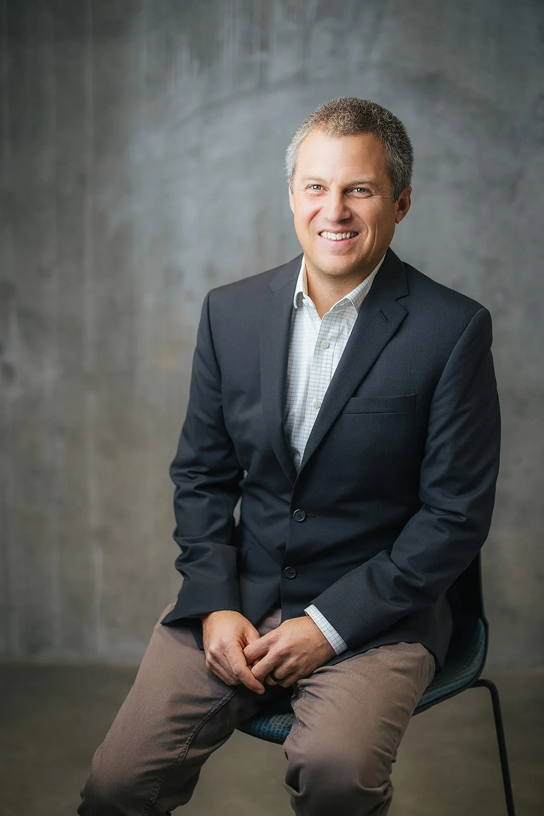 Man Sitting in Chair During Corporate Headshot Session