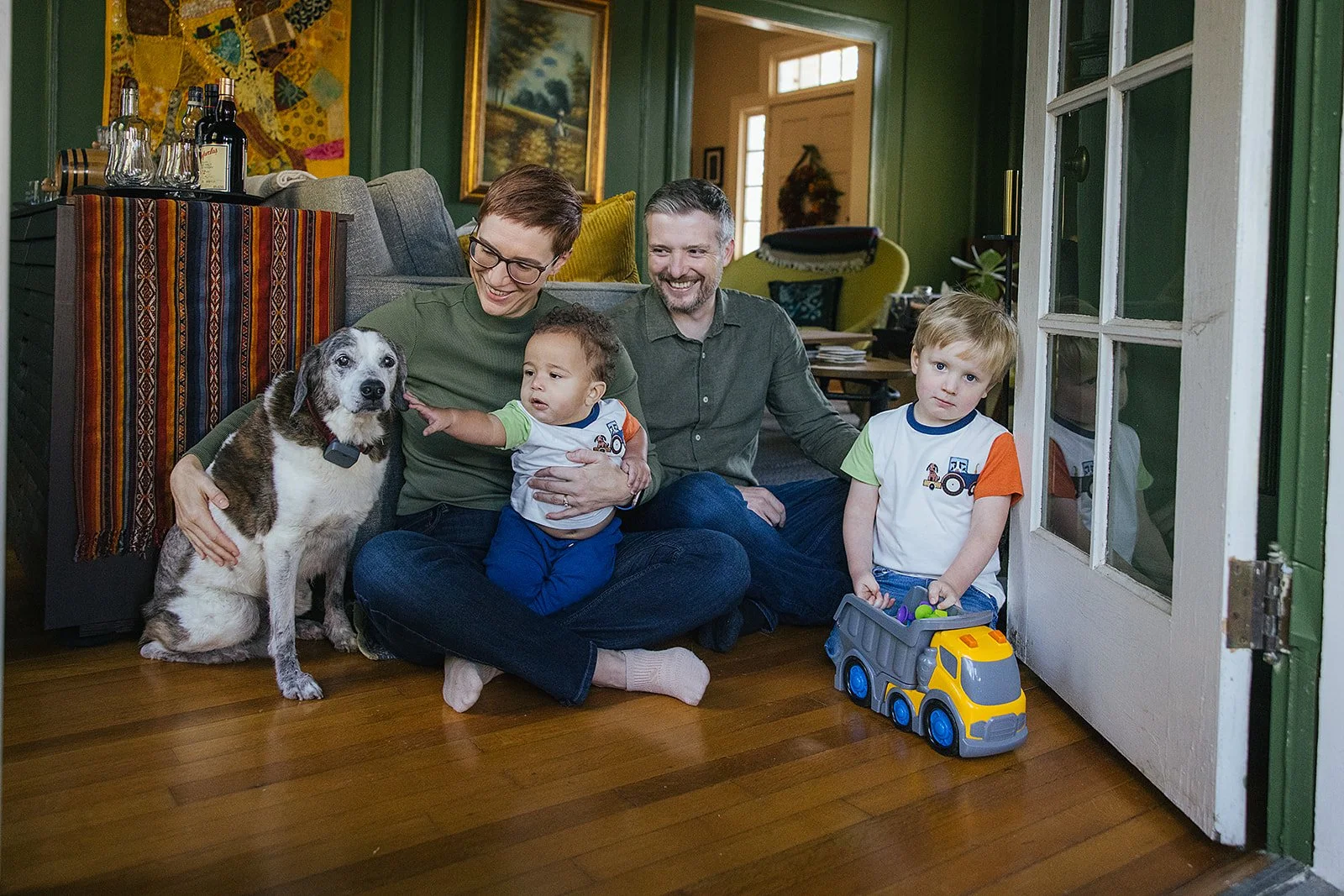 Family of Four On Living Room Floor wIth Dogs Family Photo Session