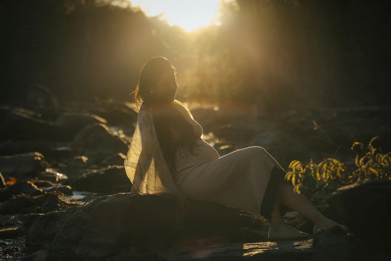 A pregnant woman on the Eno River at a maternity photoshoot in Durham, NC