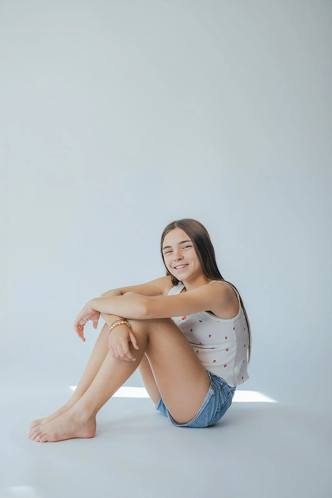 Young Girl Sitting with Plain Backdrop Child Studio Portrait
