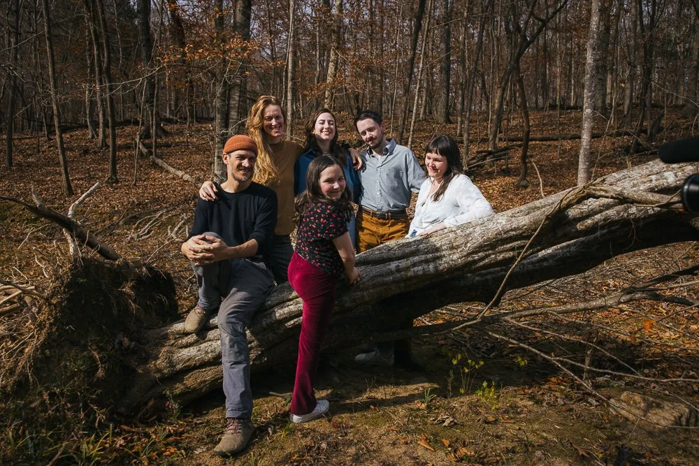 Friends Sitting on Log in Woods Durham NC