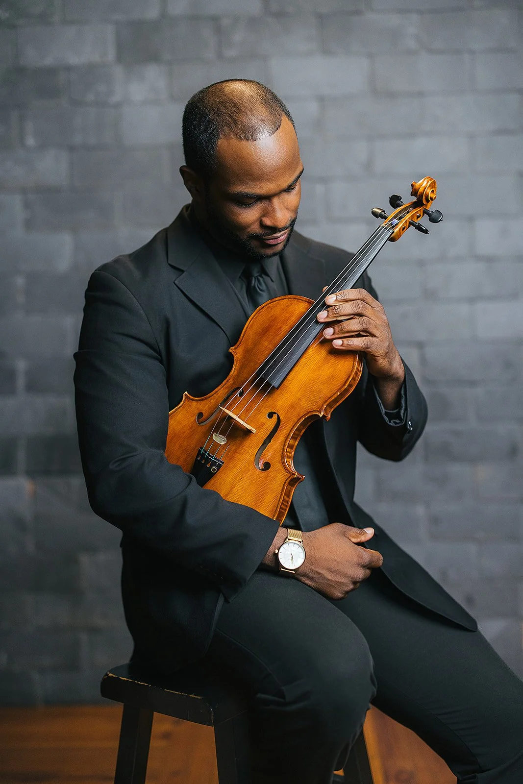 Man Holding VIolin During Chamber Orchestra of Triangle Photography Session